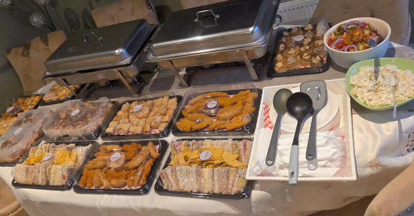 A Buffet Table spread of sandwiches, goujons, salads and hot dishes laid out for an event